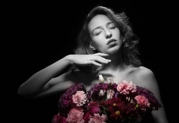 Beautiful woman with flowers on a black background.