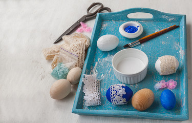 Easter eggs decorated with lace on a tray