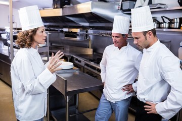 Upset head chef talking to her team