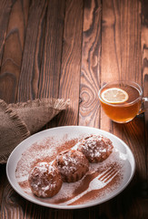 cupcakes on a plate and a cup of tea