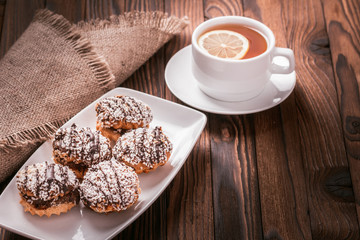 biscuits on a plate and cup of tea