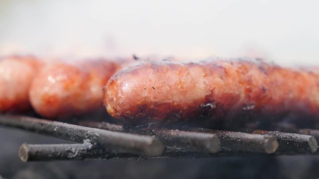 Tasty raw sausage in own juices on the barbecue 4K 2160p 30fps UltraHD footage - Mouthwatering juicy sausages on bbq smoke grilling 4K 3840X2160 UHD video 