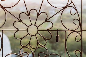 Master key on old iron  background hanging on the wrought iron bars