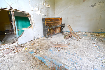 broken piano and chair in abbondoned house Lesvos Greece