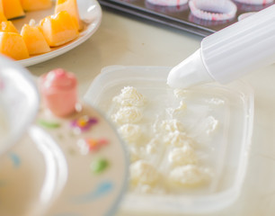 Fototapeta na wymiar Prepare the decorating squeeze whipped cream.