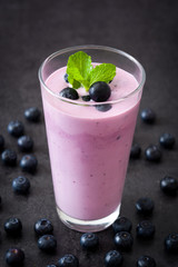 Fresh blueberry smoothie on black stone
