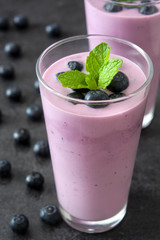 Fresh blueberry smoothie on black stone

