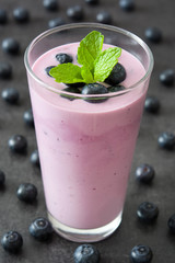 Fresh blueberry smoothie on black stone
