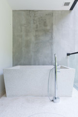 Open air Loft style bathtub and grey wall
