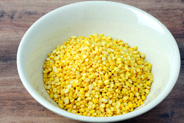 Close up of dhal lentils on a bowl on a wooden table