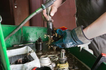 Mechanic repairing electric generator, repair of starter 
