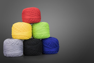 Balls of cotton thread on gray background