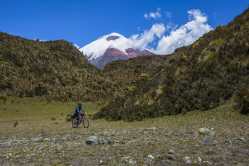 Fototapeta na wymiar Young cyclist walking in the Cotopaxi National Park