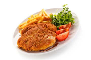 Fried pork chop, French fries and vegetables 