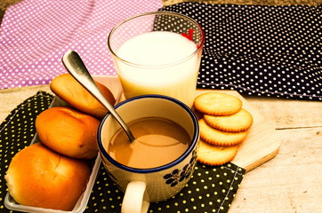 breakfast with bread coffee and milk on table background.