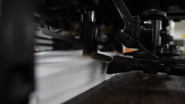 Sheet offset machine draws paper in printery