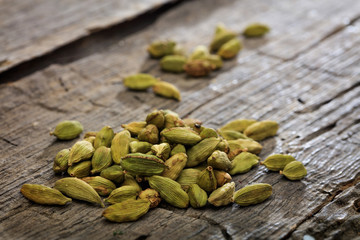 Dried cardamom pile set on old wooden surface