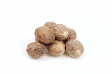 Dried nutmeg seeds, on white background