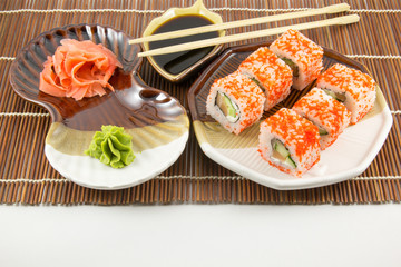 Japanese seafood sushi rolls with chopstick wasabi and ginger