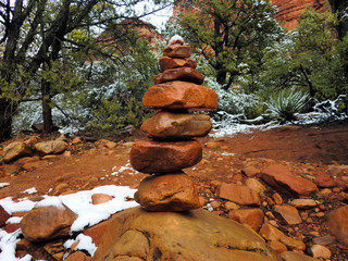 Sedona, Arizona stone cairn with red clay soil and snow - landscape color photo