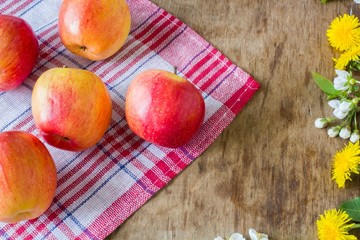 Big juicy red apples near  the flowers 