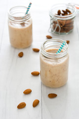 Banana smoothies on white wood

