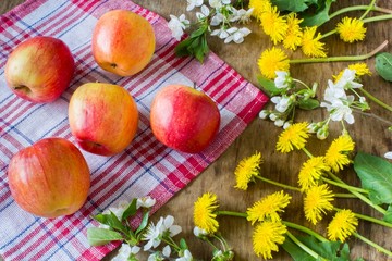 Big juicy red apples near  the flowers 