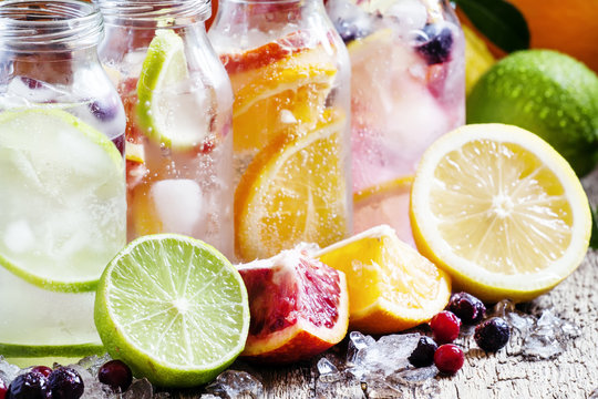 Fizzy water with citrus fruit, fresh berries and crushed ice, vi
