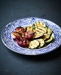 Grilled zucchini and red onion with sea salt on a plate