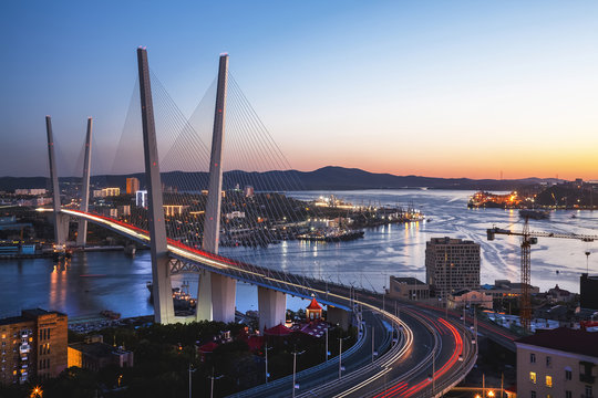 Fototapeta Panorama of Vladivostok at sunset, Far East Russia. Golden bridge.