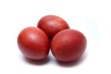 Three brown eggs on white background