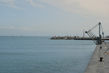 Pier with small crane and breakwater