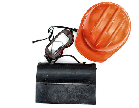 A Orange Hardhat, Old Fashioned Metal Lunchbox And A Pair Of Goggles Isolated On A White Background