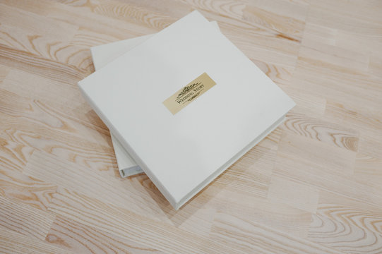 Wedding photo book and album on wooden background