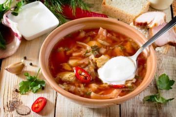 Vegetable soup with beetroot (borscht) on a wooden table, the na