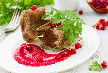 Boiled beef on the bone with sauce beet pomegranate