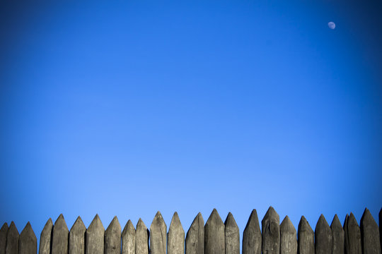 Palisade stockade palings logs and blue sky