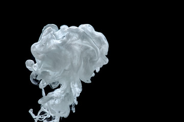 The cloud of paint in the water on the black