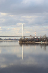 Fototapeta na wymiar Cable stayed bridge and Neva river on the outskirts of St. Petersburg at cloud spring day, Russia.