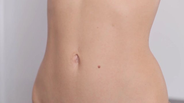 Closeup of woman's flat stomach