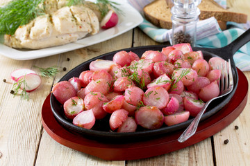 Rice fried in oil on a cast-iron frying pan