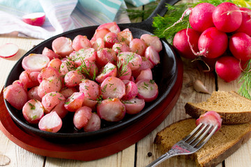 Rice fried in oil on a cast-iron frying pan