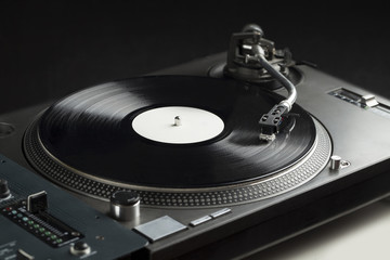 Turntable playing vinyl close up with needle on the record