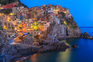 Fototapeta premium Sunset in Manarola.Manarola is a small town, in the province of La Spezia, Liguria, northern Italy. It is the second smallest of the famous Cinque Terre towns frequented by tourists.