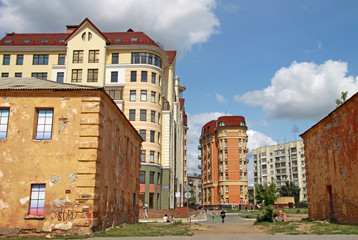 OMSK, RUSSIA - JULY 02, 2010: Architectural and historical  complex of Omsk fortress, view of old barracks with modern residential buildings in the background