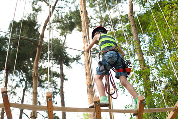 Six years boy on rope-way in the forest