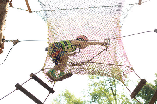Six years boy on rope-way in the forest