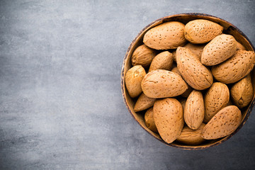 Group of almond nuts with leaves.Wooden background.