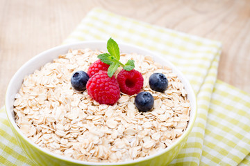Oatmeal porridge with berries. Raspberries and blueberries.