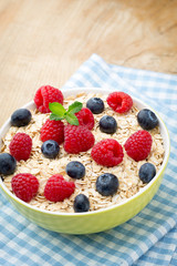 Oatmeal porridge with berries. Raspberries and blueberries.